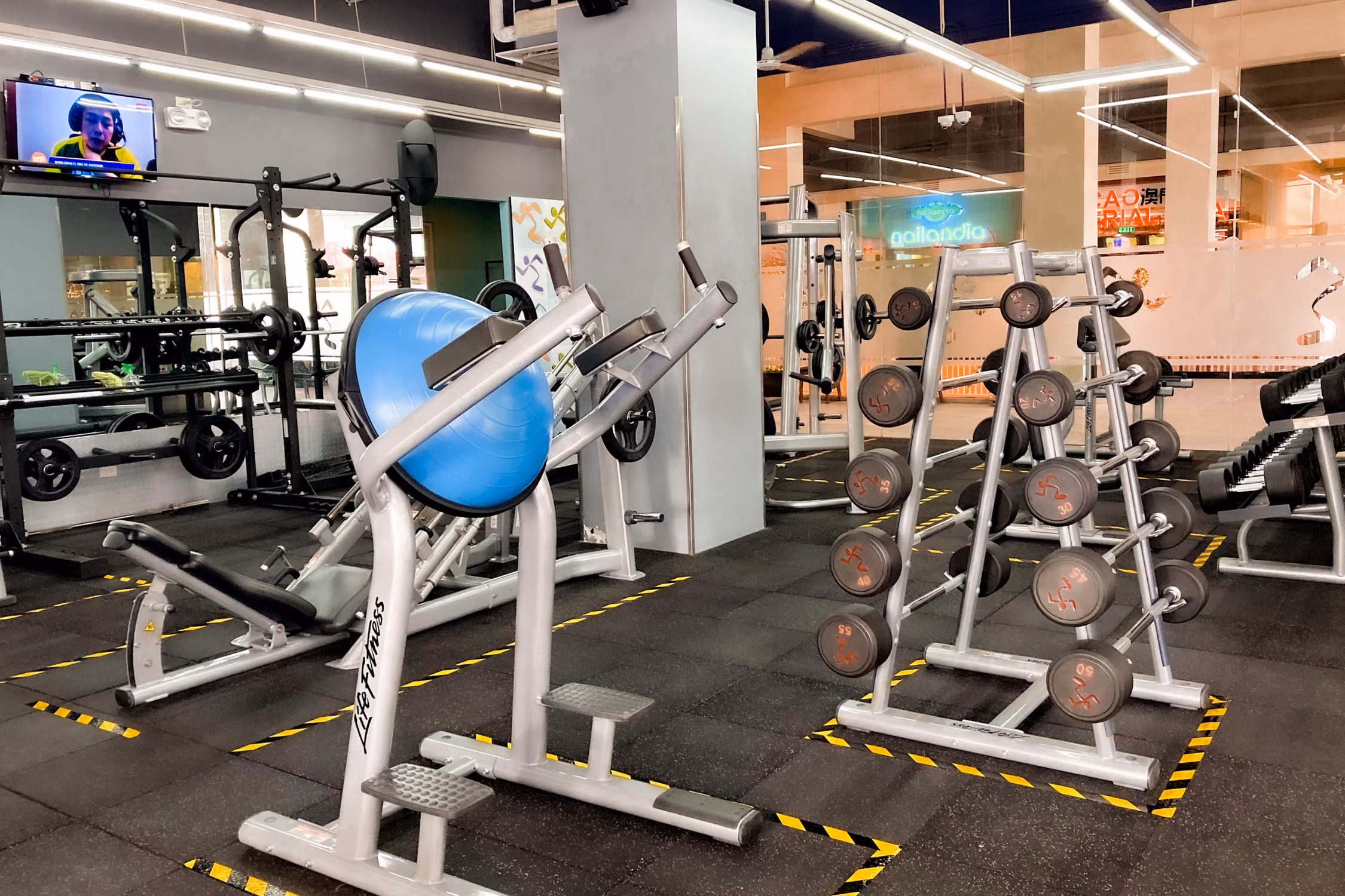 Commercial gym floor with exercise machines and free weights