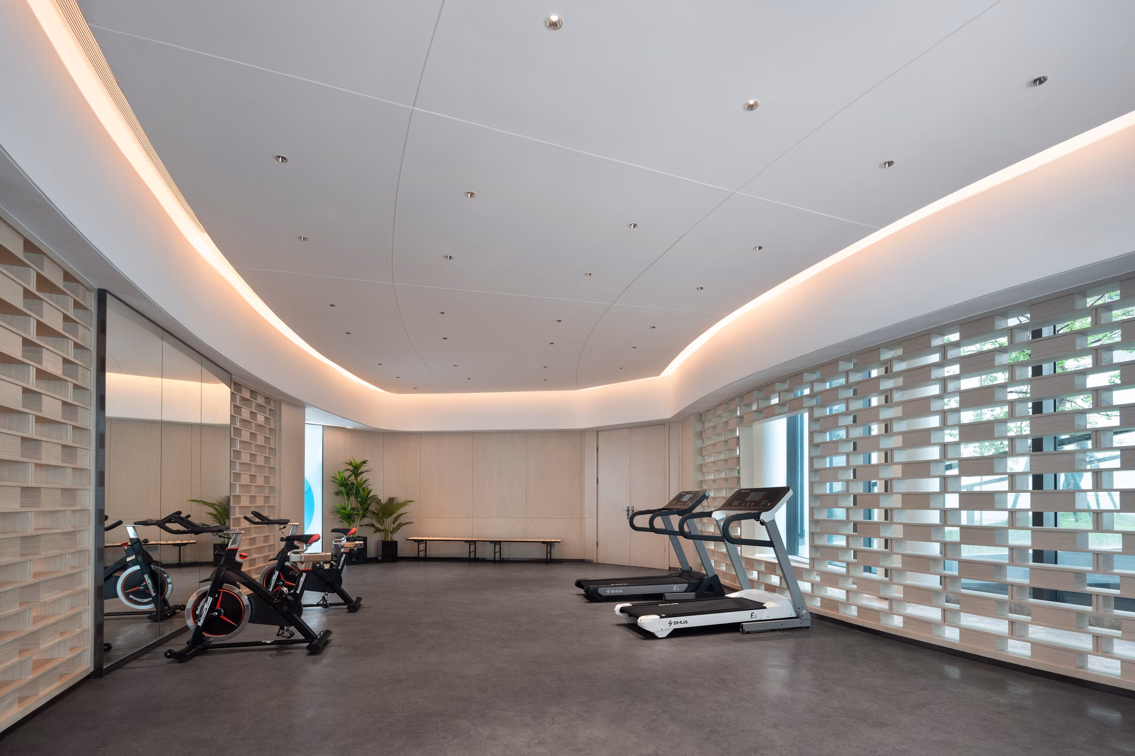 Stylish hotel fitness room with treadmills and stationary bikes