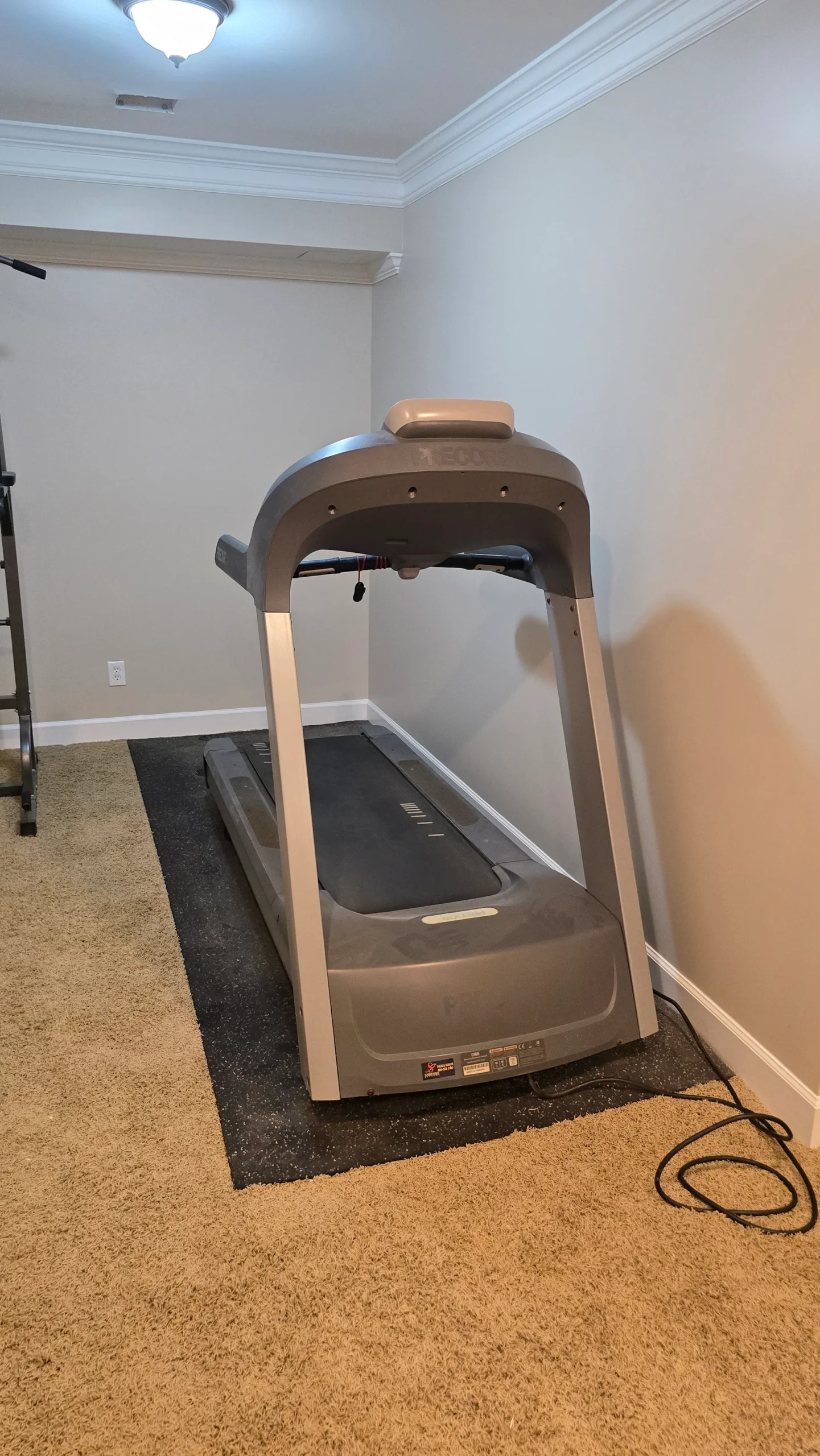 Treadmill installed in a residential workout space